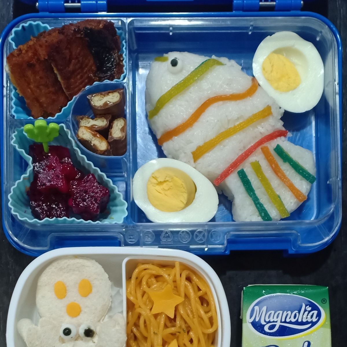 Fish-shaped rice in a colorful lunchbox, symbolizing success for the new year.