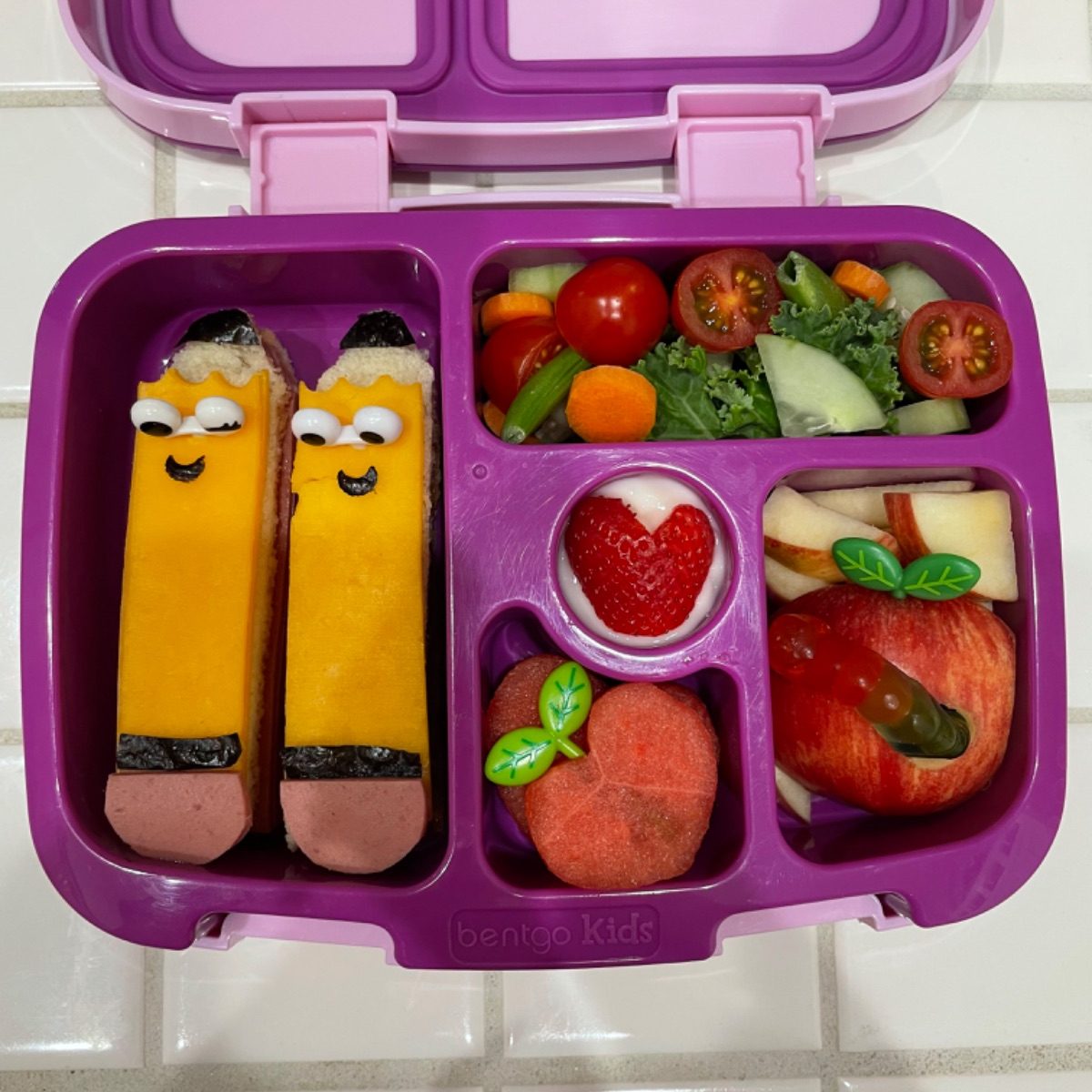 Cute pencil-shaped sandwiches with fruits and veggies in a kid's Bentgo lunchbox