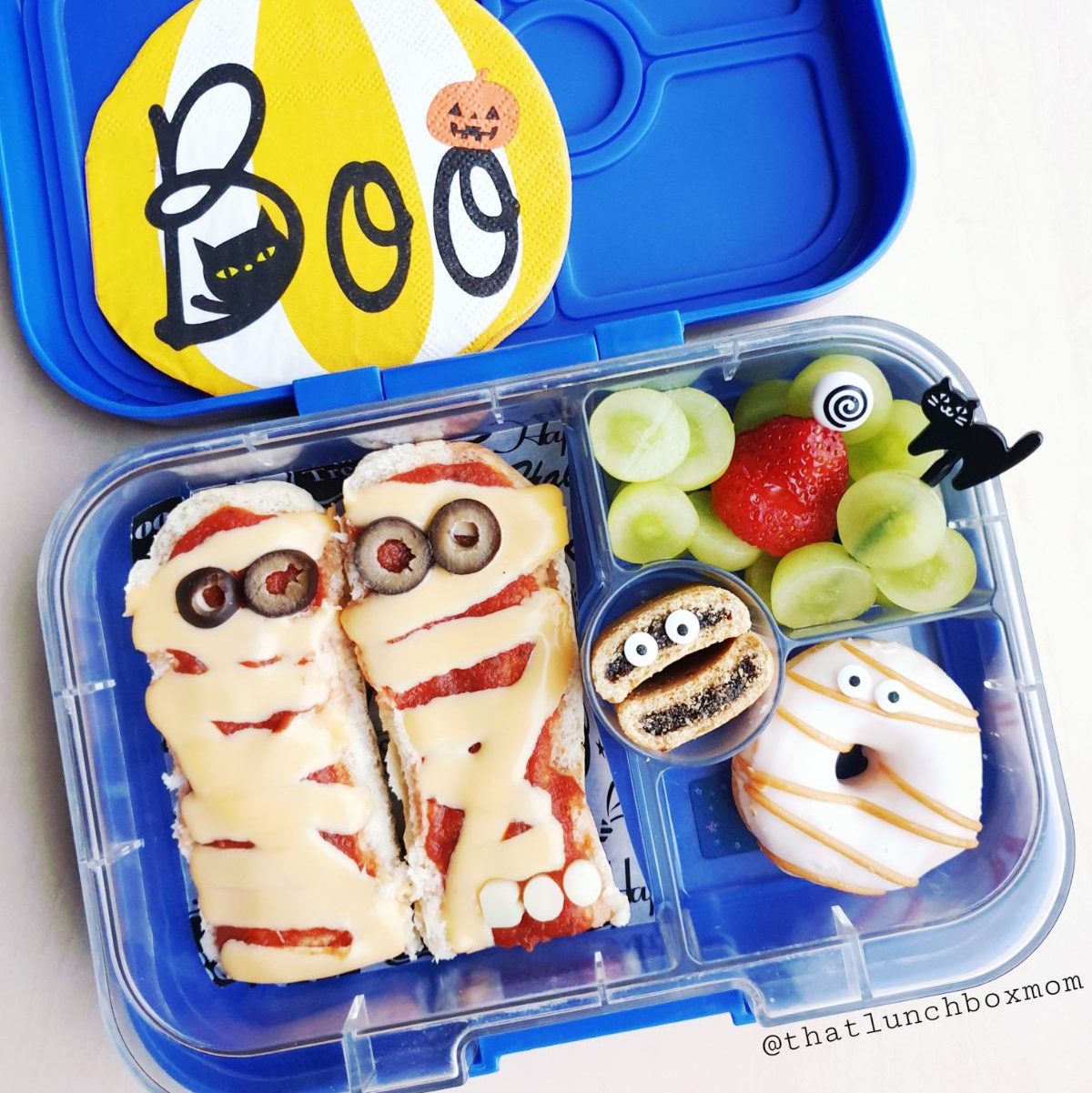 Mummy pizza in a kid's Yumbox bento lunchbox for celebrating Halloween
