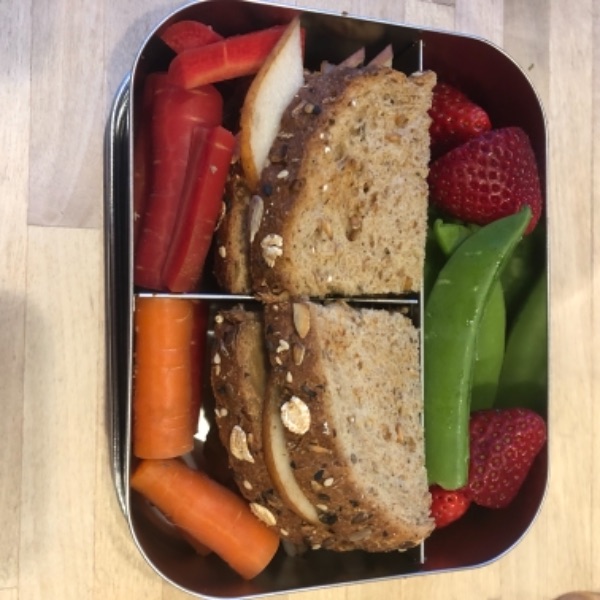 Sunflower seed butter and pear sandwich in a kid's lunchbox