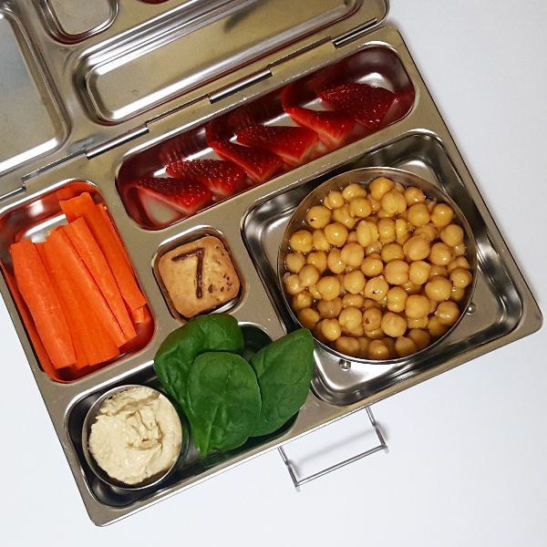 Hummus, carrot sticks, and chickpea salad in a Planetbox stainless steel lunchbox