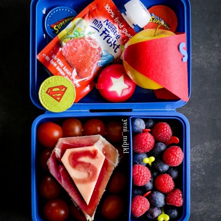 Prosciutto ham and cheese Superman-themed sandwich in a colorful kids lunchbox, perfect for superhero lunch ideas.