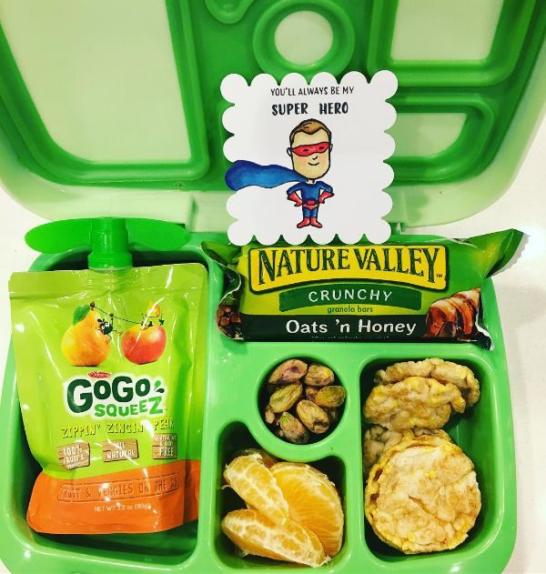 Superman-themed lunchbox note inside a Bentgo kids lunchbox with snacks, celebrating positivity and encouragement for school lunch.