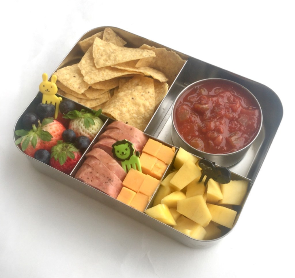 Salsa and tortilla chips in a stainless steel lunchbox for a kid's lunch at school