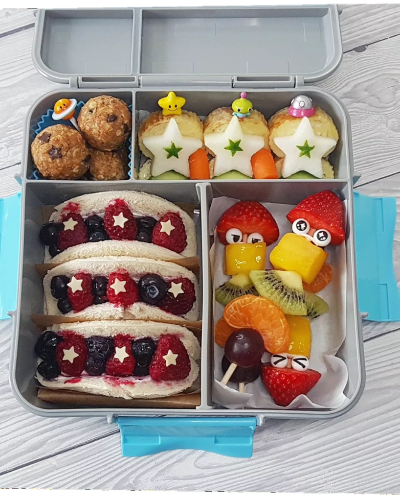 energy bites and delicious fruits in a kids lunchbox