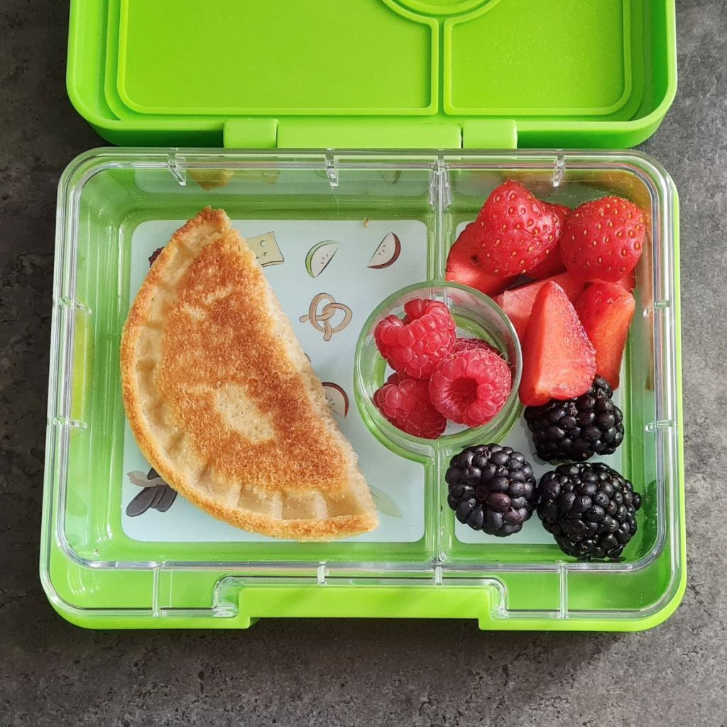 Fresh gruits and toast in a kid's snack box