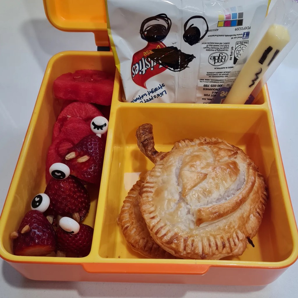 Homemade Halloween-themed empanadas in a kid's lunchbox