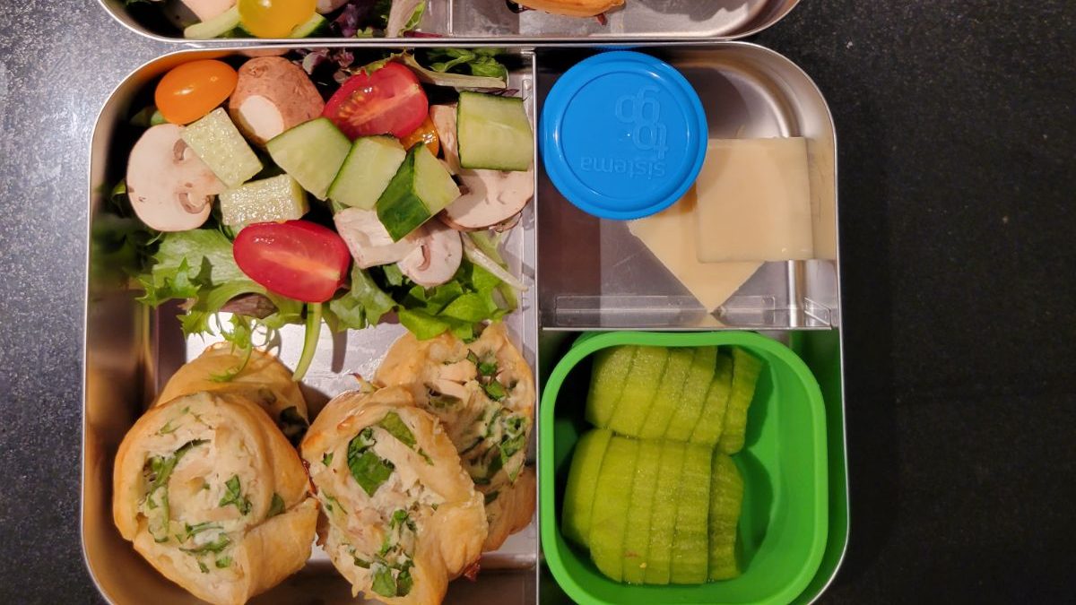 Spinach and cheese puff pastry bites in a kid's Lunchbot stainless steel bento lunchbox