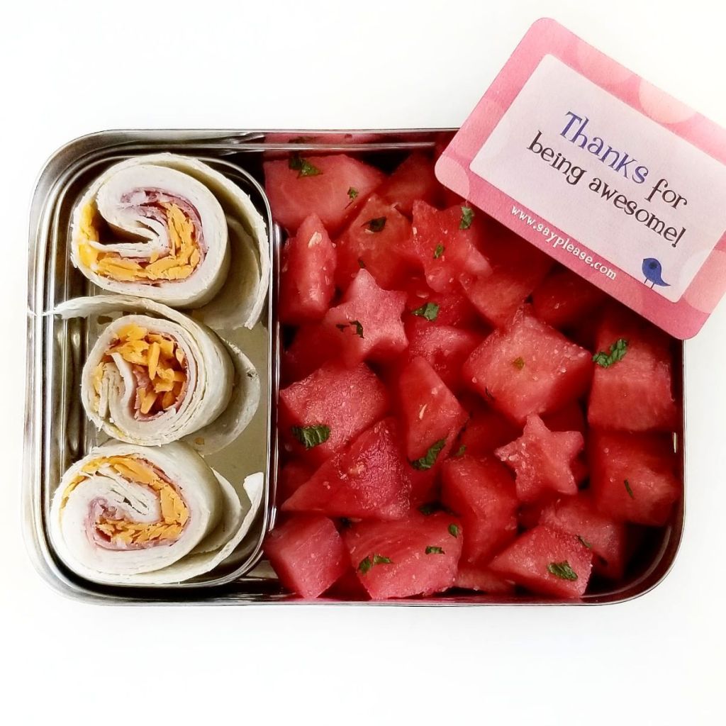 3 turkey and cheese wraps with watermelon chunks in a stainless steel Lunchbot bento lunchbox