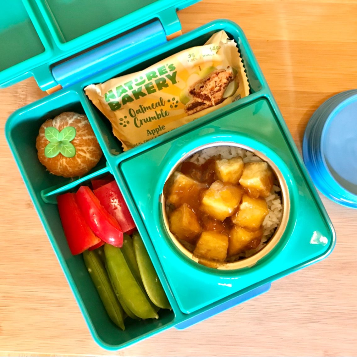 Hot lunch for kid with apricot tofu in an Omie Lunchbox
