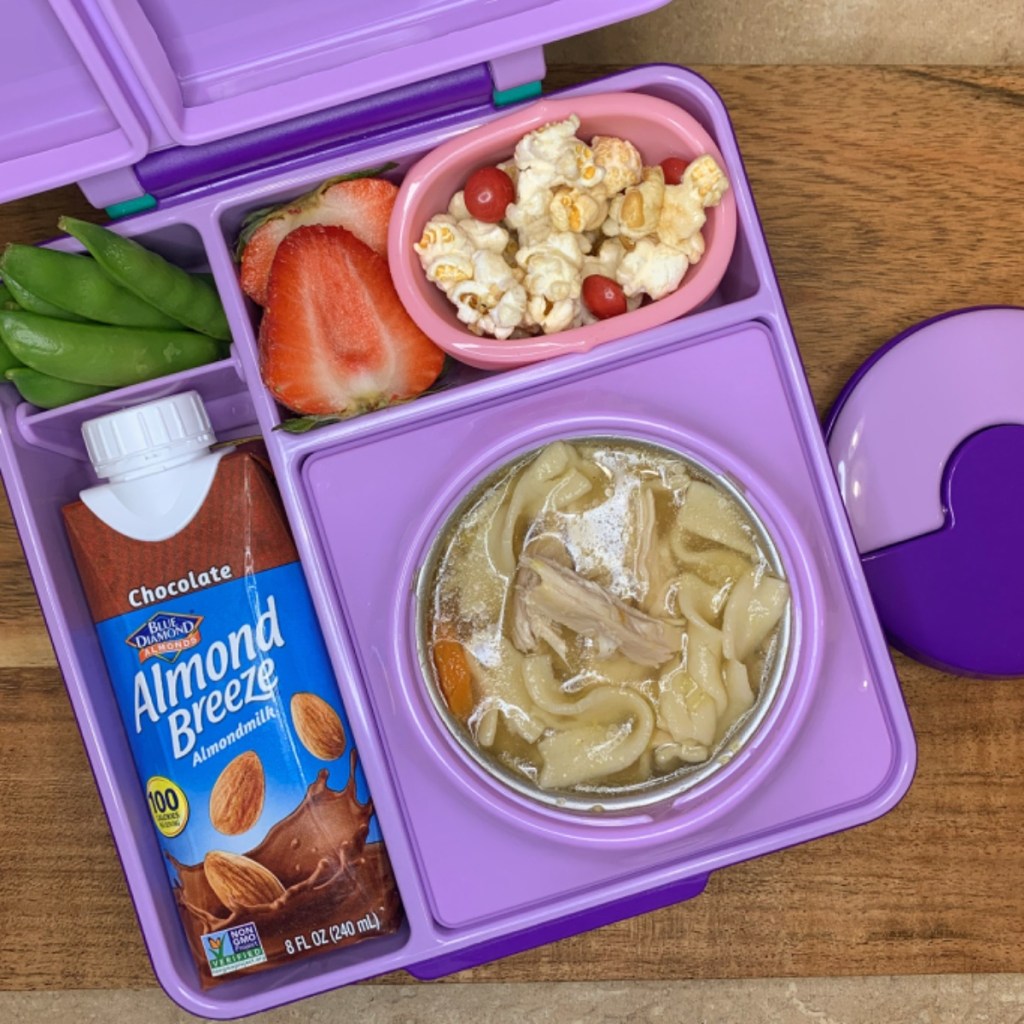 Chicken soup and almond milk in a kids' lunchbox