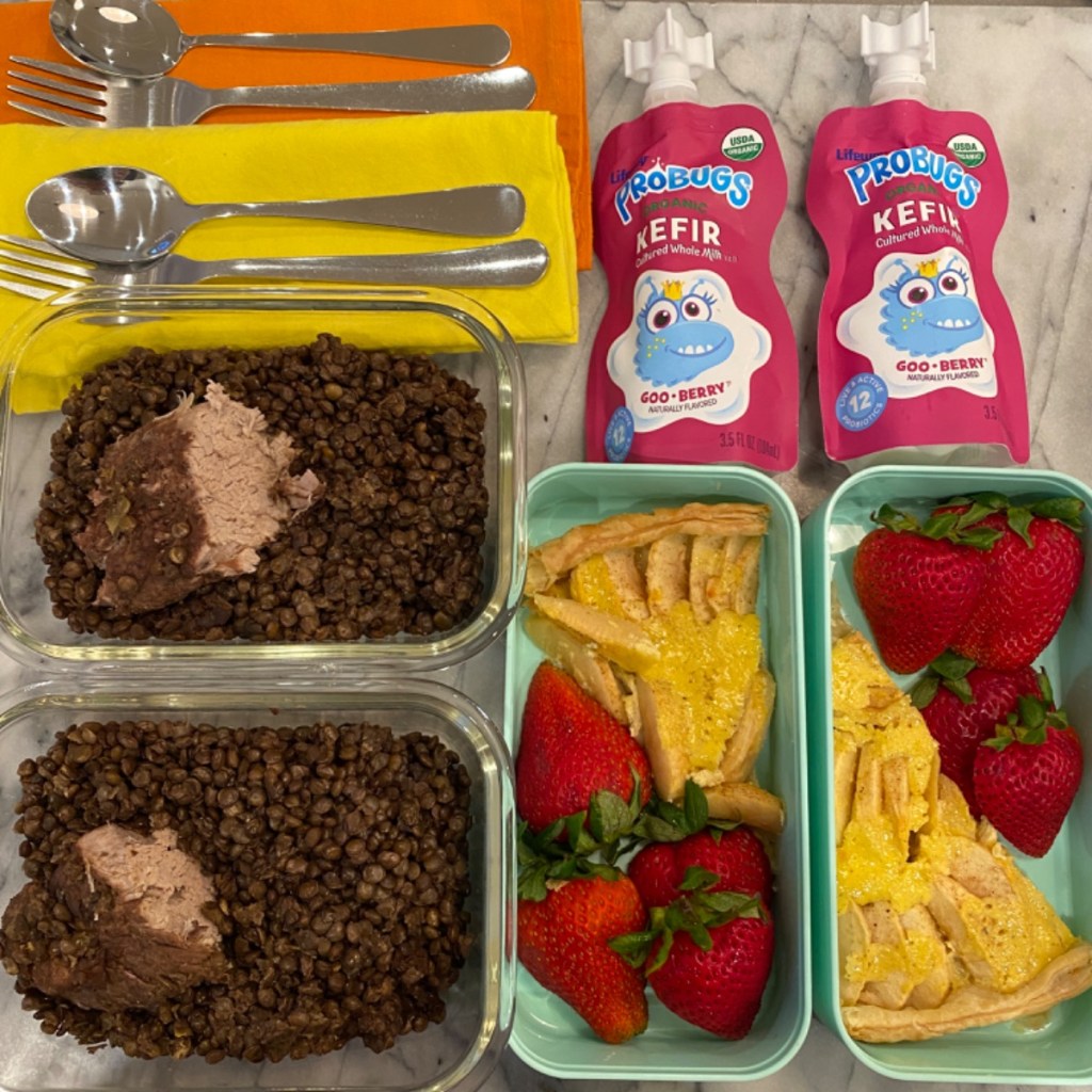 Homemade petit salé with lentils and pork chop for kids' meals at school