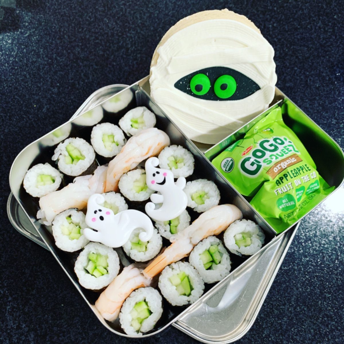 Halloween lunchbox idea for kids with sushi lunch and a huge mummy cookie