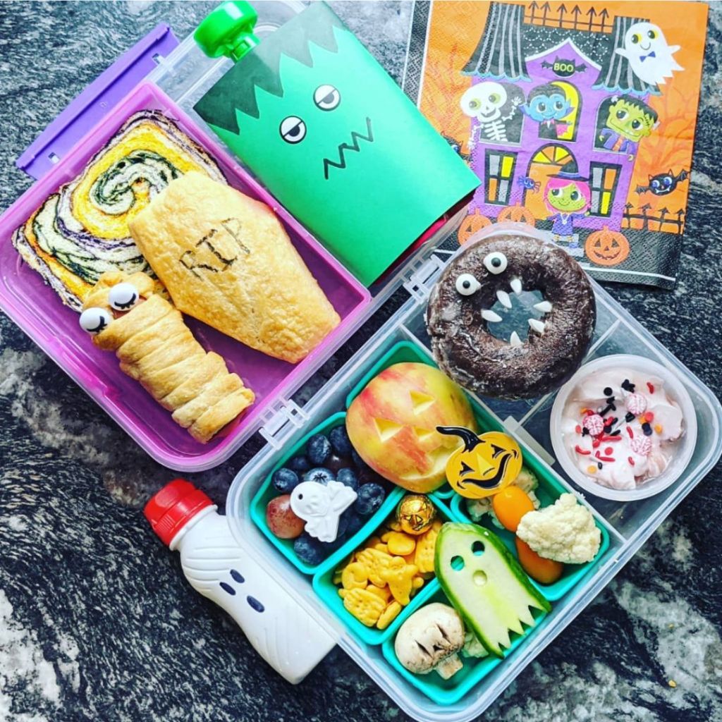 A kid bento lunchbox with Halloween paper napkin on the side