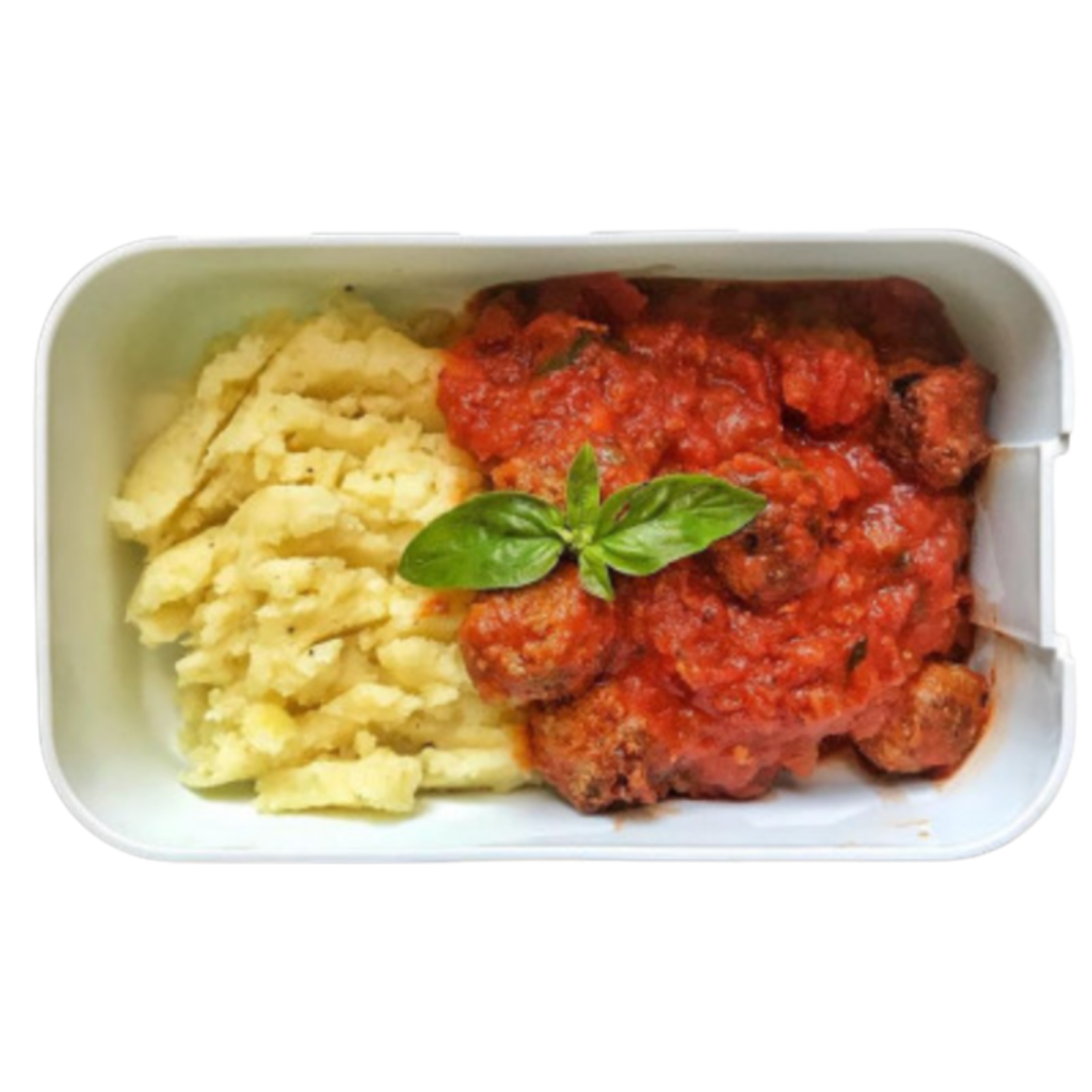 A kid's lunchbox with meatballs, tomato sauce, potato purée and basil leaves.