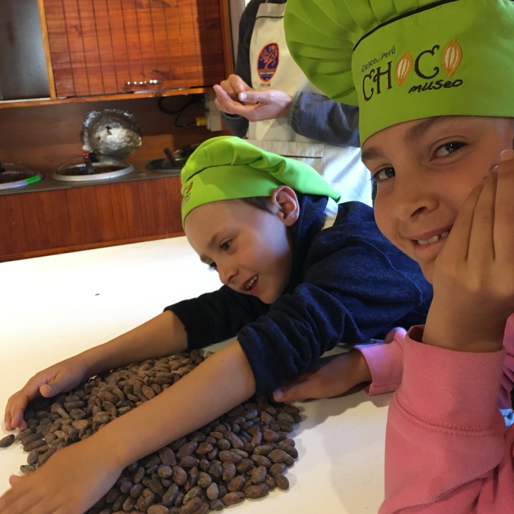 Teuko.com the Lunchbox Community. Teuko Kids play with dried cocoa beans at the ChocoMuseo in Cusco.