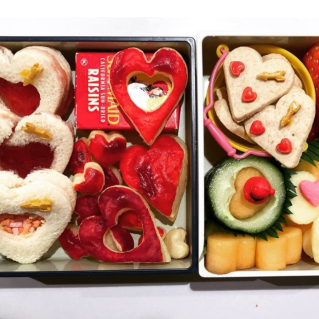 Cookies and heart-shaped sandwiches. Valentine's Day bento lunch box idea for kids.