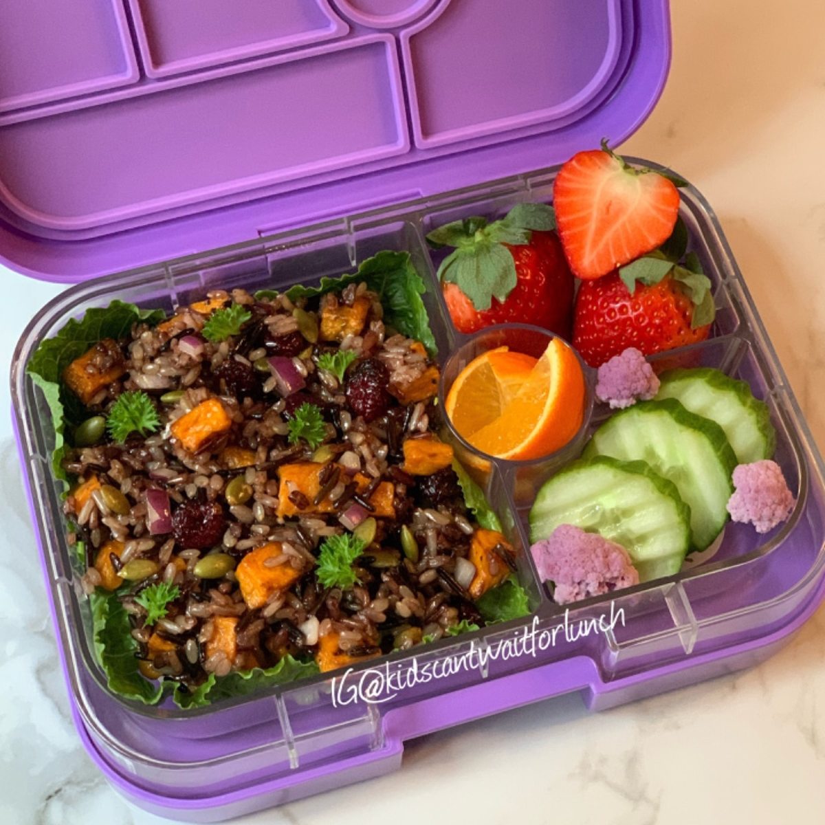 Pumpkin seeds rice salad in a purple lunchbox.