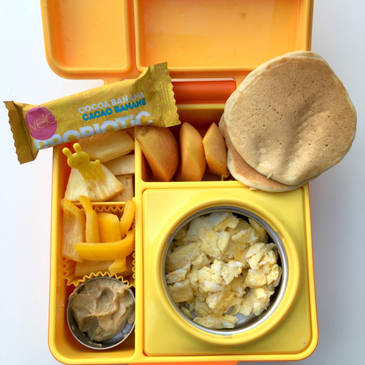 Scrambled eggs and pancakes for a kid's lunch at school
